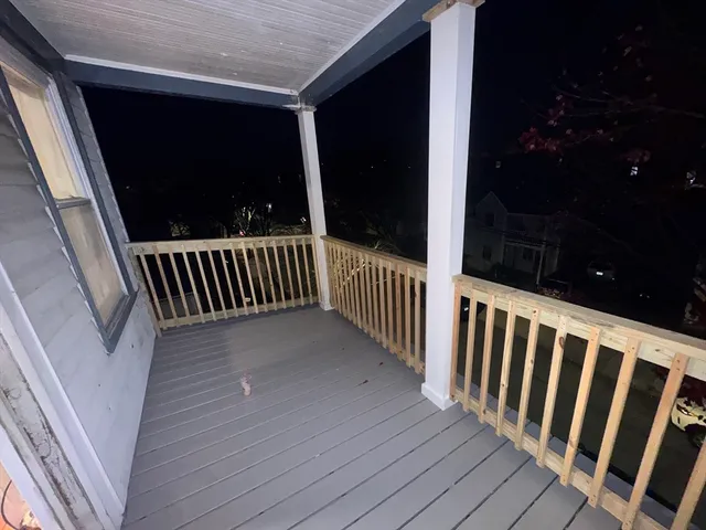a view of a balcony with wooden floor