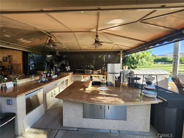 a view of a kitchen with kitchen island a large window in it