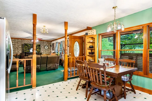 a dining room with furniture water view and a floor to ceiling window