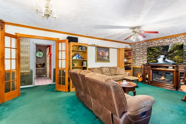 a living room with furniture a flat screen tv and a fireplace