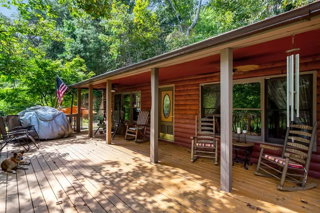 a view of a patio with table and chairs and wooden fence