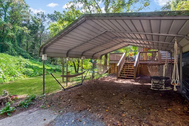 a backyard of a house with table and chairs