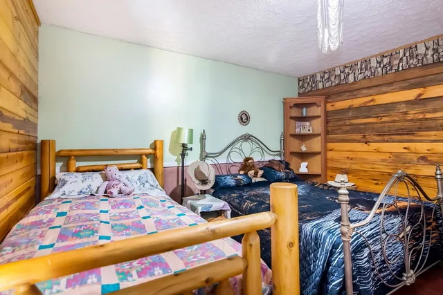 a bedroom with two beds and a large window