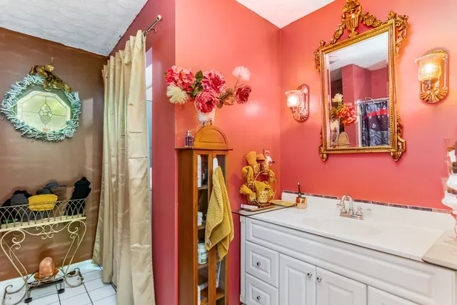 a bathroom with a sink mirror and vanity