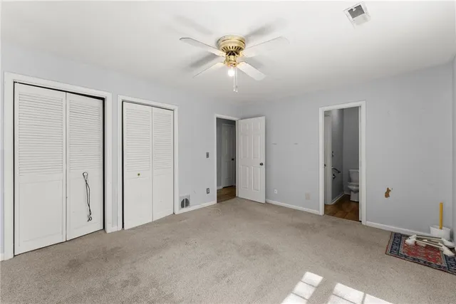 a view of an empty room with a ceiling fan