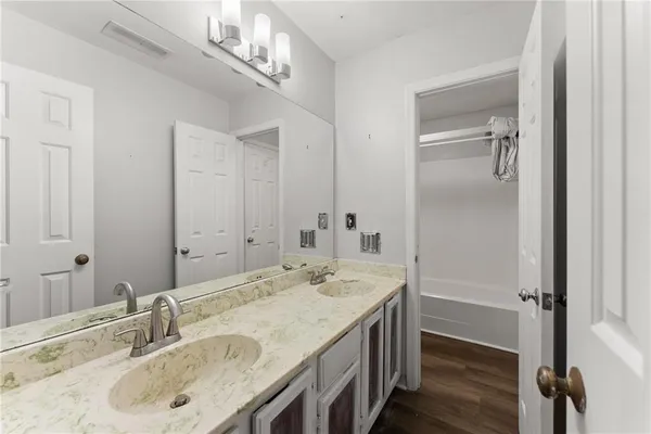 a bathroom with a granite countertop sink and a mirror