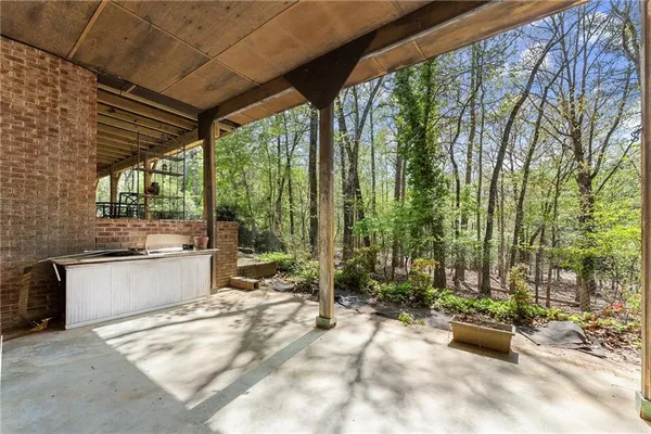 a view of a patio with table and chairs and potted plants