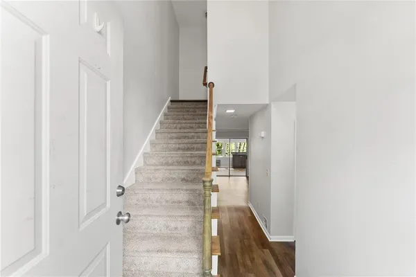 a view of a hallway with wooden floor and entryway