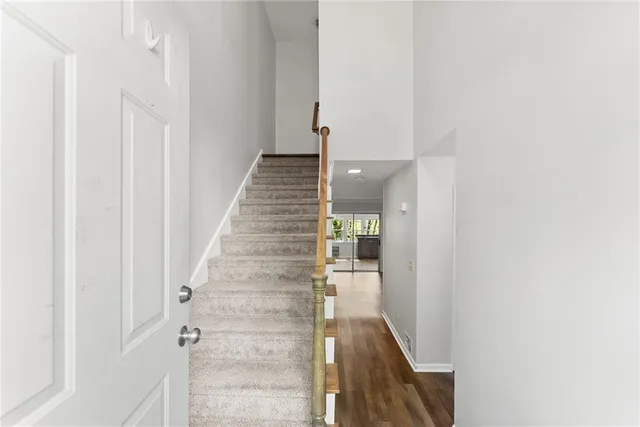 a view of a hallway with wooden floor and entryway