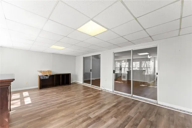 a room with wooden floor and natural light