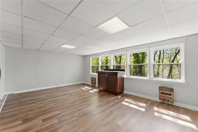 a view of a room with wooden floor and stainless steel appliances