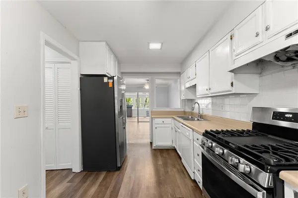 a kitchen with stainless steel appliances granite countertop a refrigerator and a stove