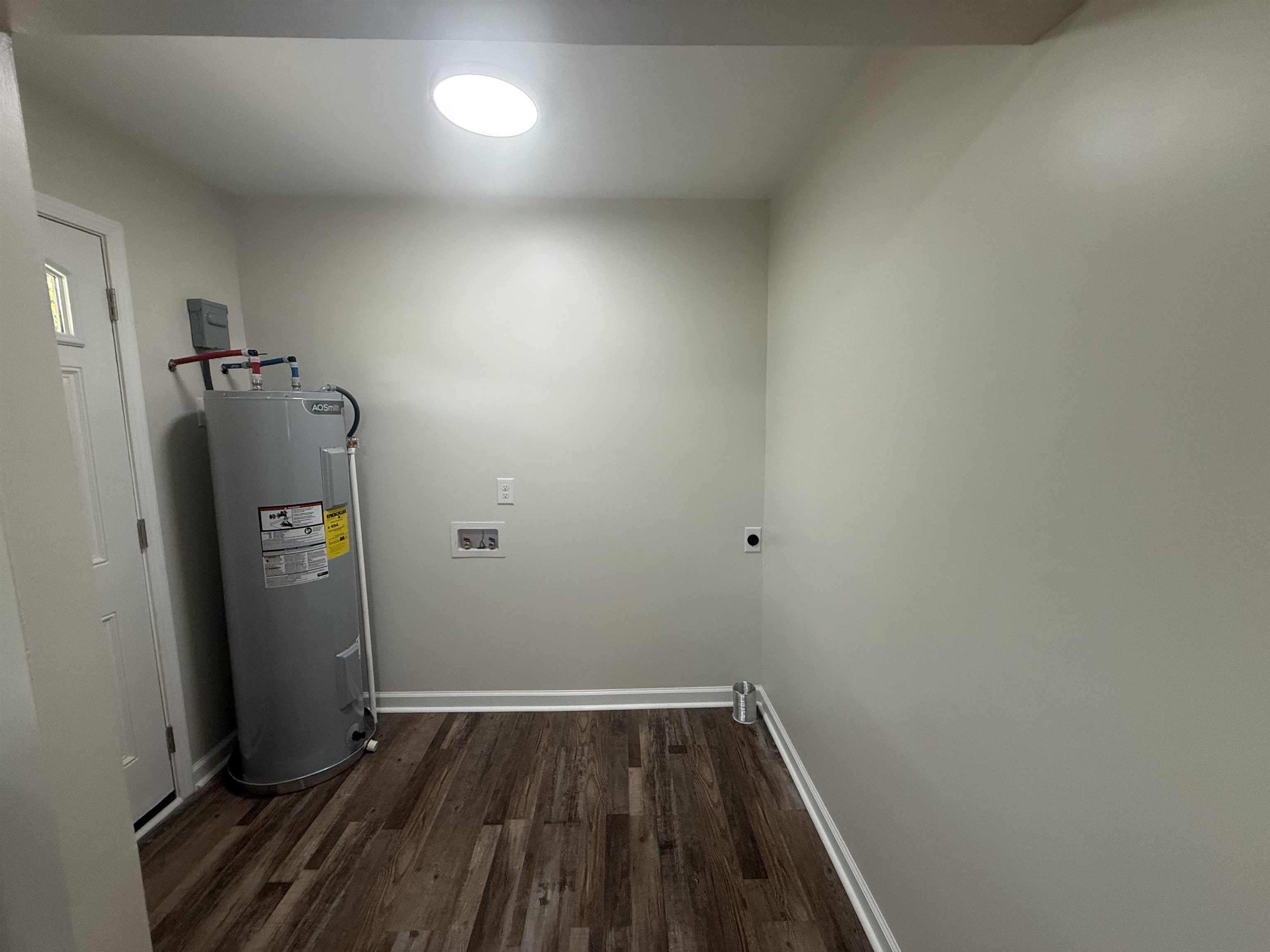 195 Poole Road Moscow, TN 38057 - Photo 16 of 21 Utility room with wood-finish flooring and a contemporary overhead light fixture