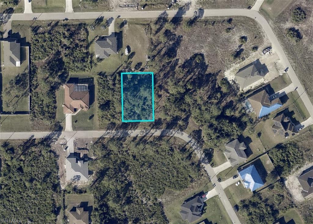 123 Pearson Street Lehigh Acres, FL 33974 - Photo 2 of 7 an aerial view of a house with a yard