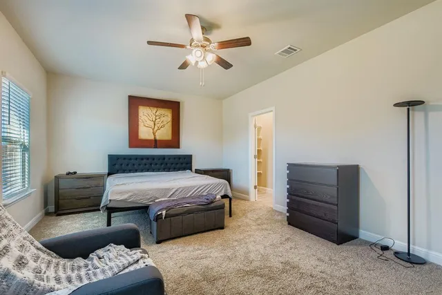 a bedroom with furniture and a window