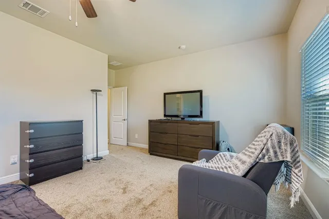 a bedroom with furniture and a television