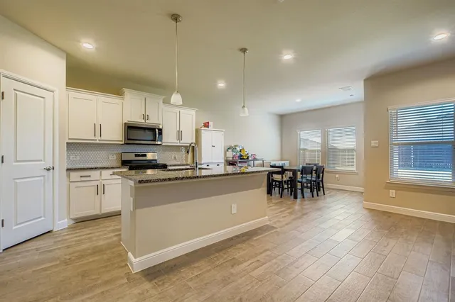 a kitchen with sink cabinets and microwave