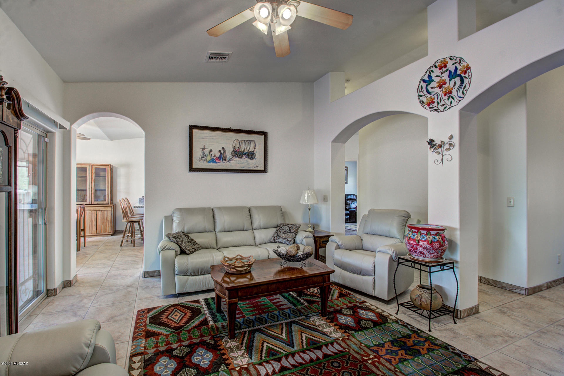 1689 Círculo Alameda Rio Rico, AZ 85648 - Photo 15 of 26 a living room with furniture and a chandelier