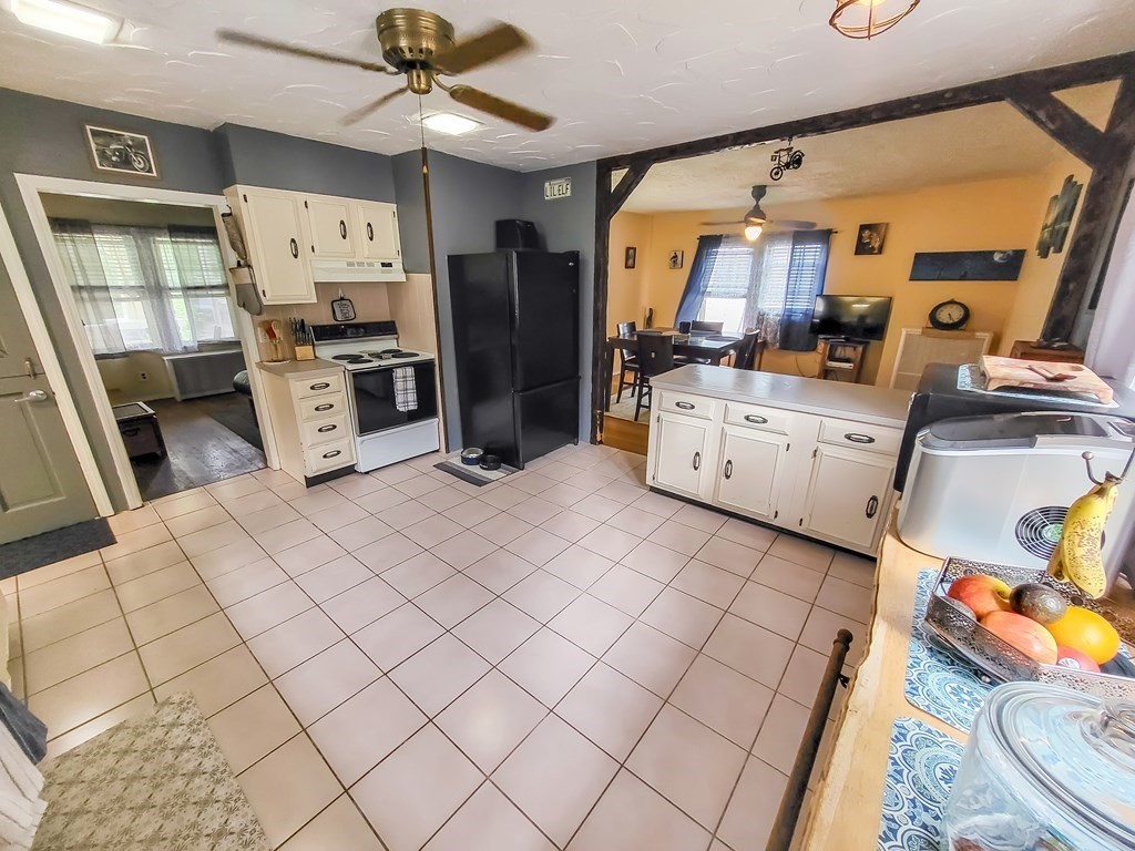 77 Olean Street Worcester, MA 01602 - Photo 11 of 42 a open kitchen with stainless steel appliances kitchen island granite countertop a refrigerator and a stove