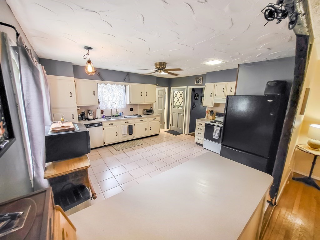 77 Olean Street Worcester, MA 01602 - Photo 12 of 42 a kitchen with refrigerator and cabinets