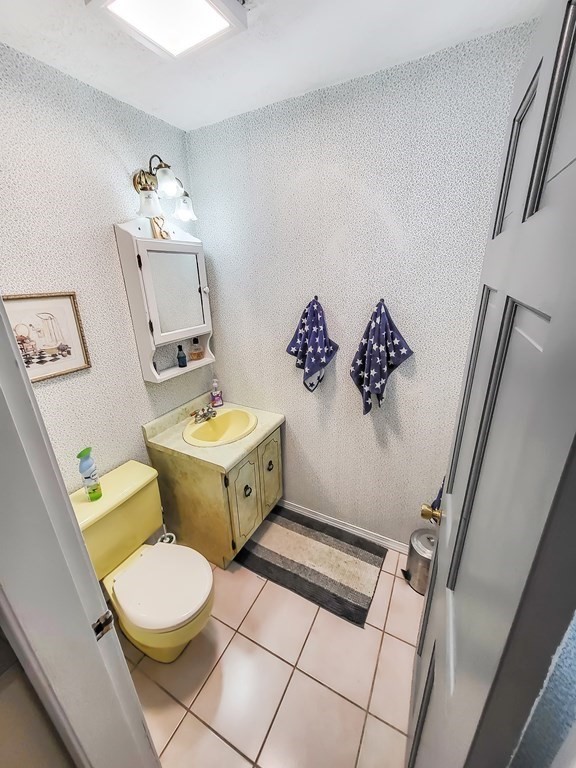 77 Olean Street Worcester, MA 01602 - Photo 13 of 42 a bathroom with a sink a toilet and mirror