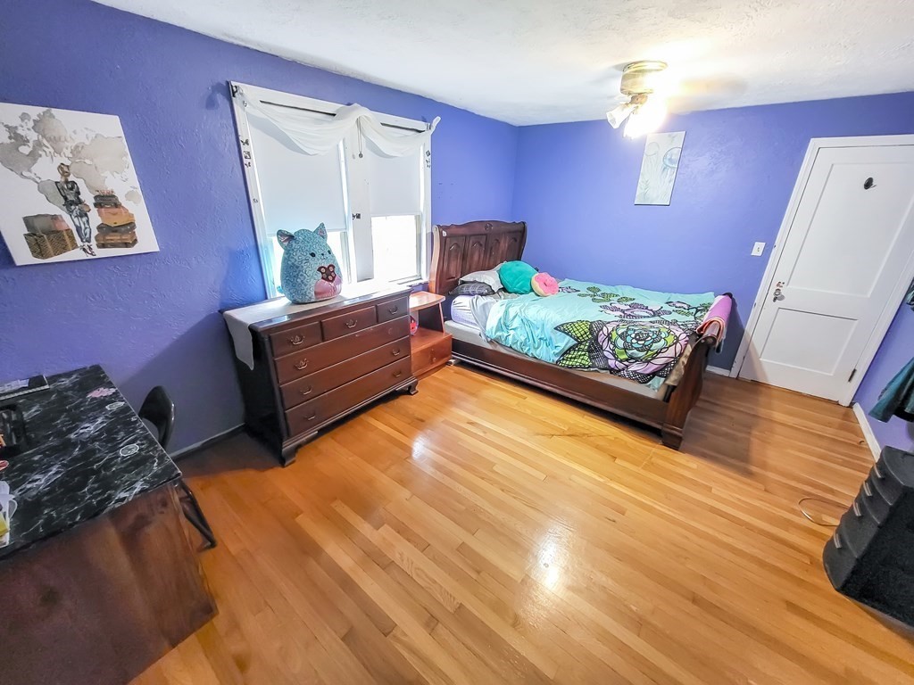77 Olean Street Worcester, MA 01602 - Photo 24 of 42 a bed room with furniture and a wooden floor