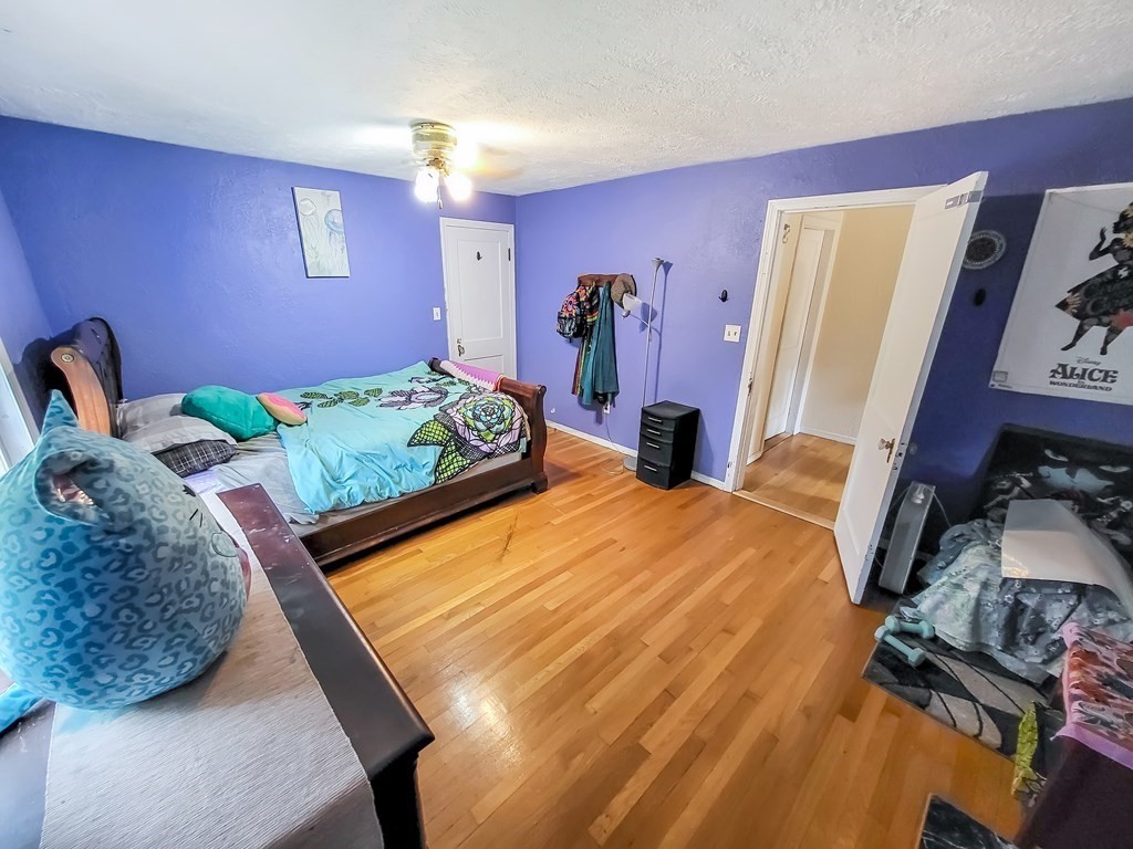 77 Olean Street Worcester, MA 01602 - Photo 25 of 42 a bed sitting in a bedroom next to a window