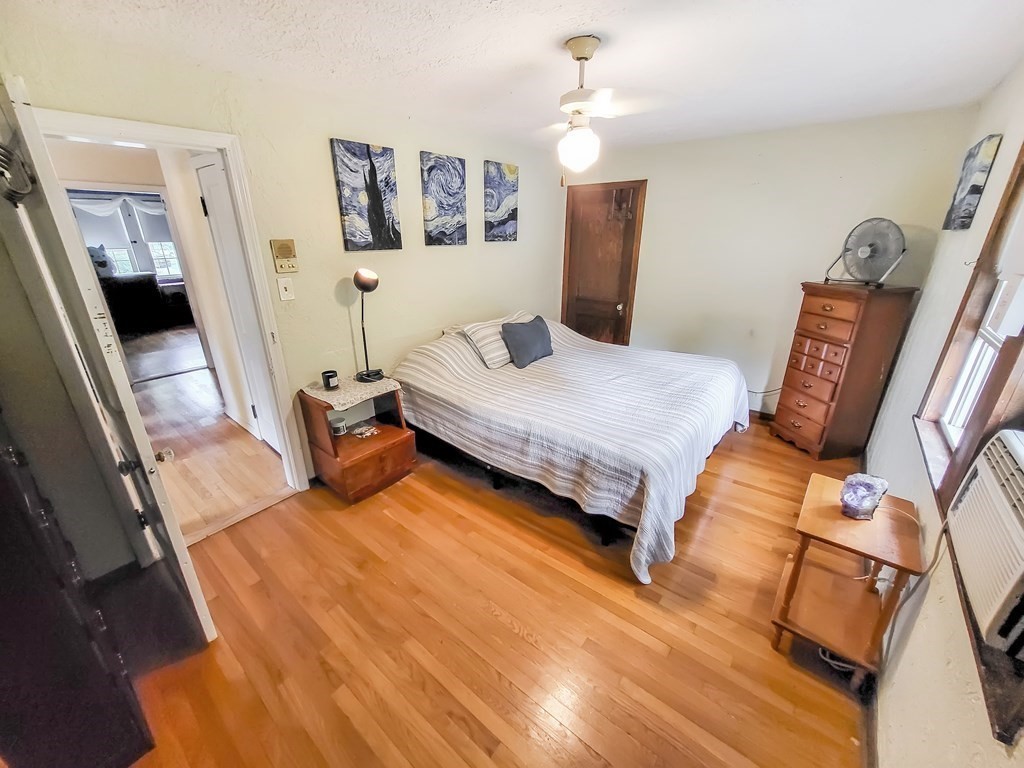 77 Olean Street Worcester, MA 01602 - Photo 26 of 42 a bedroom with a bed and wooden floor