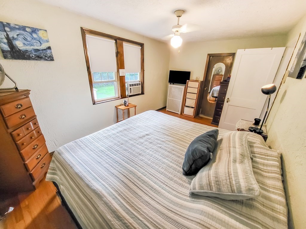 77 Olean Street Worcester, MA 01602 - Photo 28 of 42 a bedroom with a bed wooden floor and window