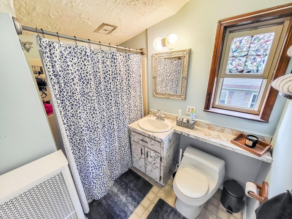 77 Olean Street Worcester, MA 01602 - Photo 29 of 42 a bathroom with a sink toilet and shower