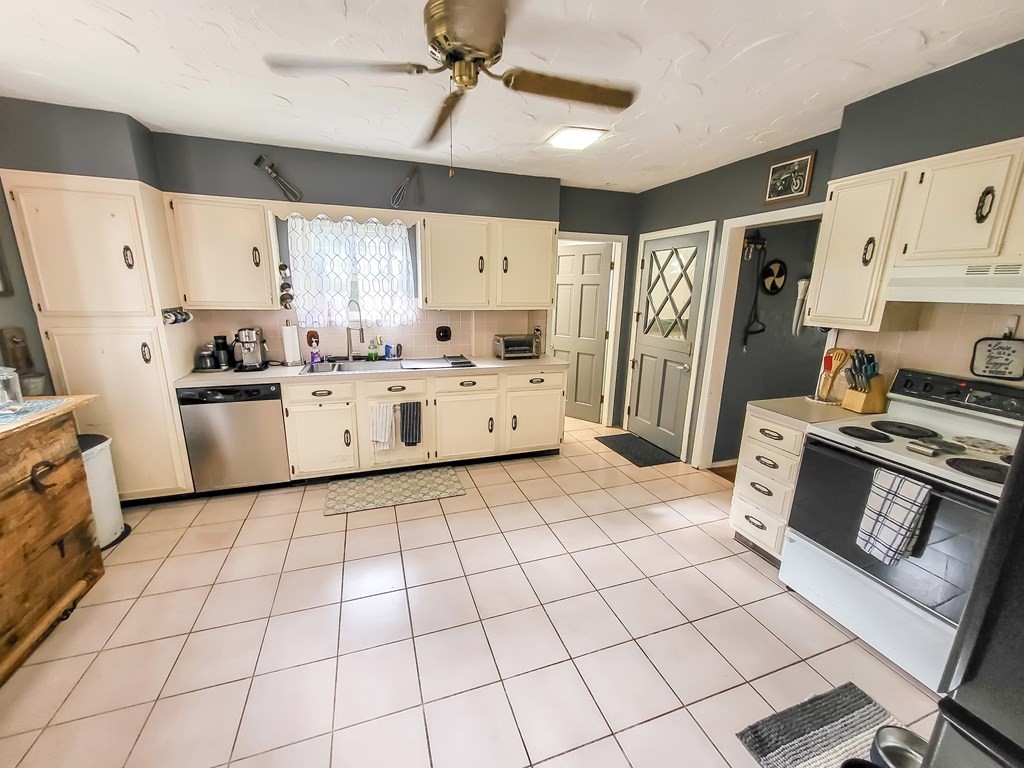 77 Olean Street Worcester, MA 01602 - Photo 34 of 42 a kitchen with stainless steel appliances a stove a sink and a refrigerator
