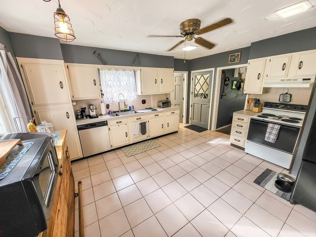 77 Olean Street Worcester, MA 01602 - Photo 35 of 42 a kitchen with granite countertop cabinets a sink a window and stainless steel appliances