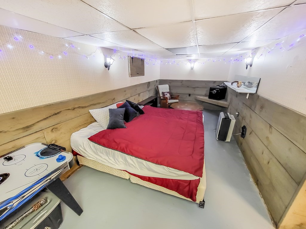 77 Olean Street Worcester, MA 01602 - Photo 37 of 42 a bedroom with bed and a chandelier