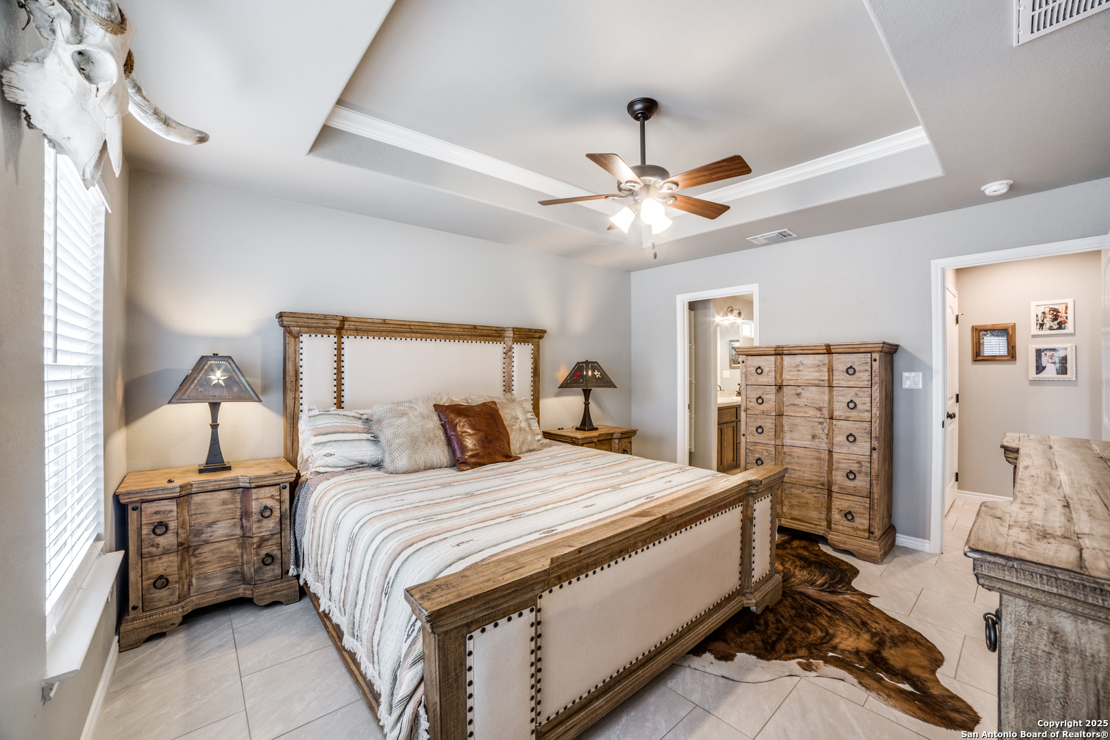 388 Bluff View Drive Spring Branch, TX 78070 - Photo 13 of 25 a bedroom with a bed ceiling fan and a rug