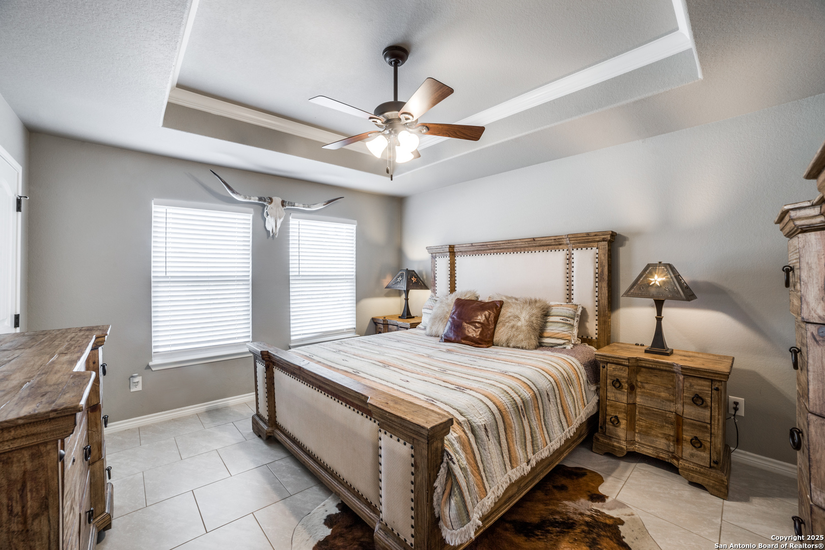 388 Bluff View Drive Spring Branch, TX 78070 - Photo 14 of 25 a bedroom with a bed and a chandelier