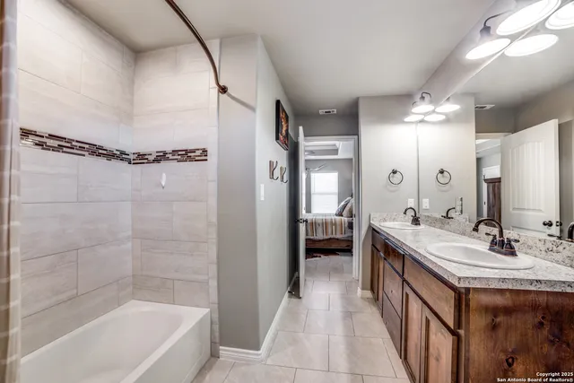 a bathroom with a tub a sink shower and a mirror