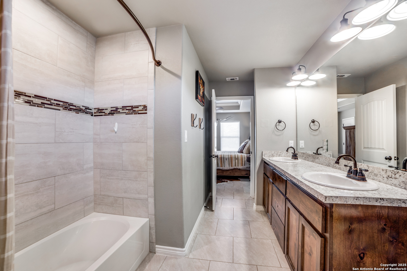 388 Bluff View Drive Spring Branch, TX 78070 - Photo 16 of 25 a bathroom with a tub a sink shower and a mirror