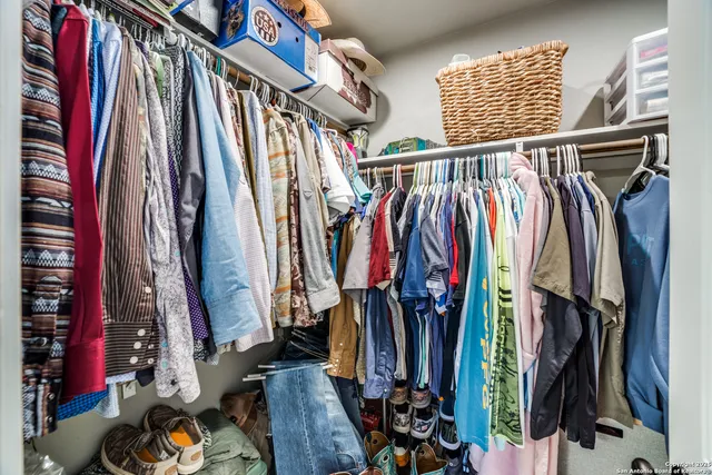 a view of walk in closet with clothes