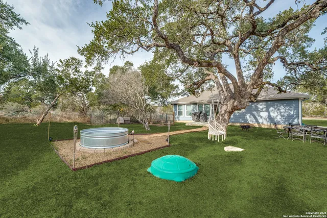 a backyard of a house with table and chairs