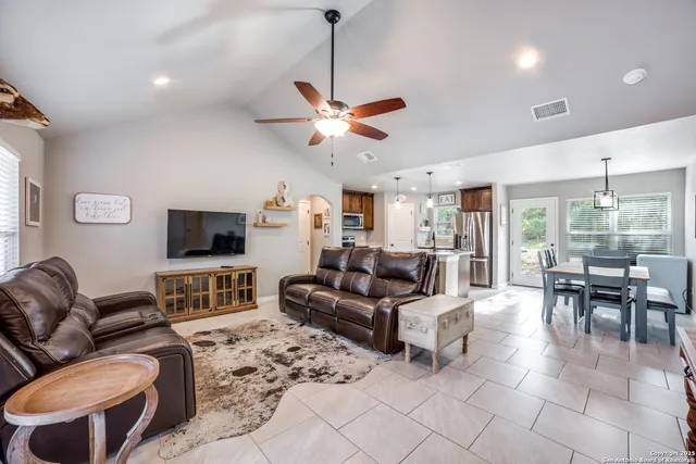 a living room with furniture a dining table and chairs