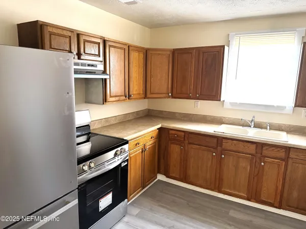 a kitchen with wooden cabinets and a sink