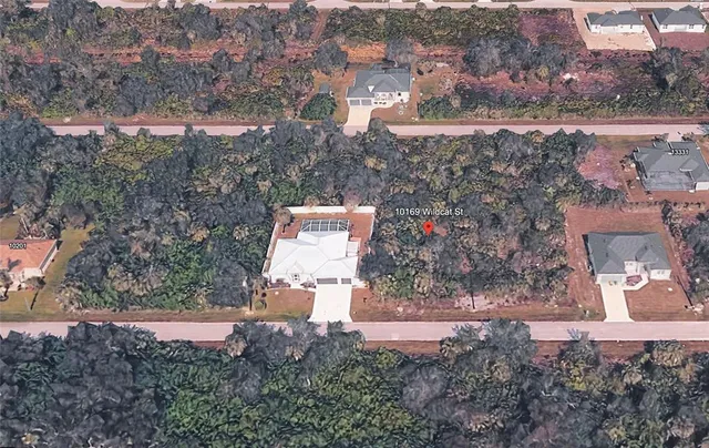 an aerial view of residential house with outdoor space and trees