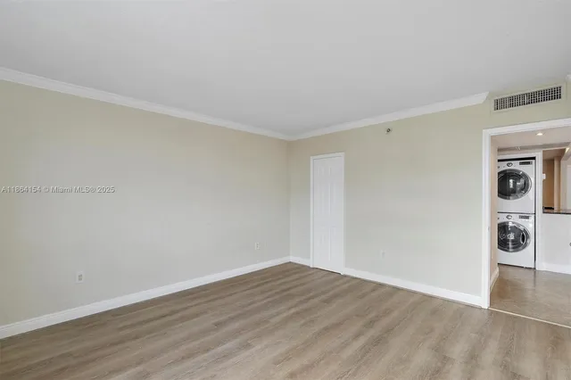 a view of an empty room and wooden floor