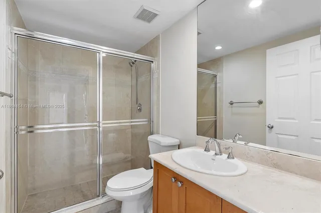 a bathroom with a sink toilet and shower