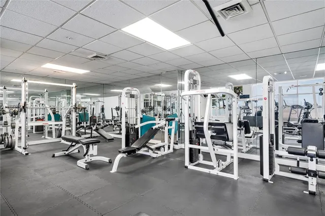 a view of a hallway with furniture and a potted plant