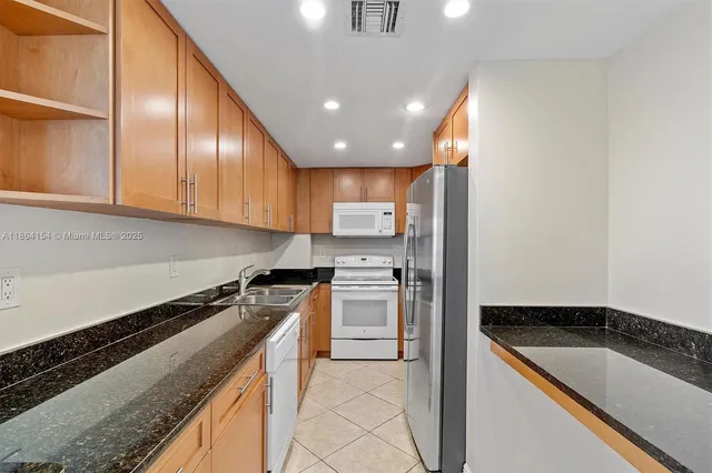 a kitchen with a sink cabinets and stainless steel appliances