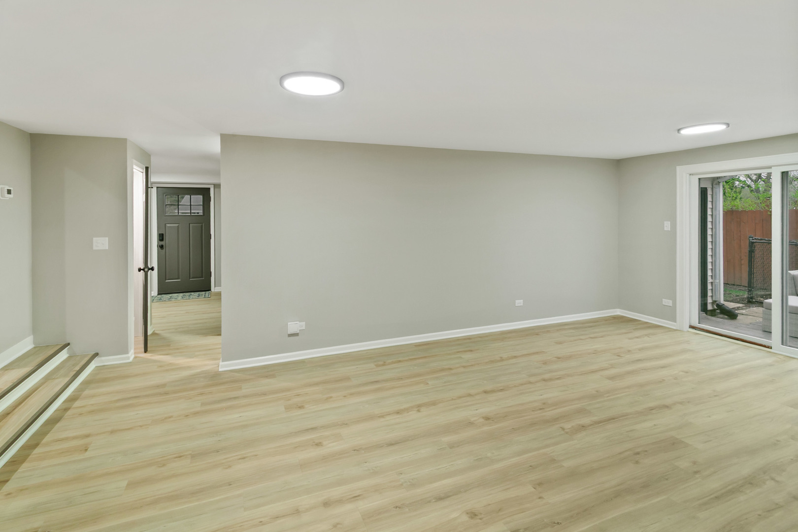 1554 Chickasaw Drive Naperville, IL 60563 - Photo 14 of 32 a view of an empty room with wooden floor and a window