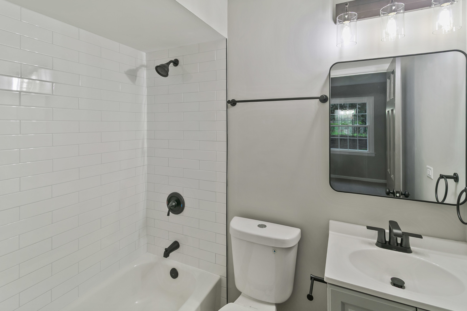 1554 Chickasaw Drive Naperville, IL 60563 - Photo 19 of 32 a bathroom with a toilet a sink a mirror and shower