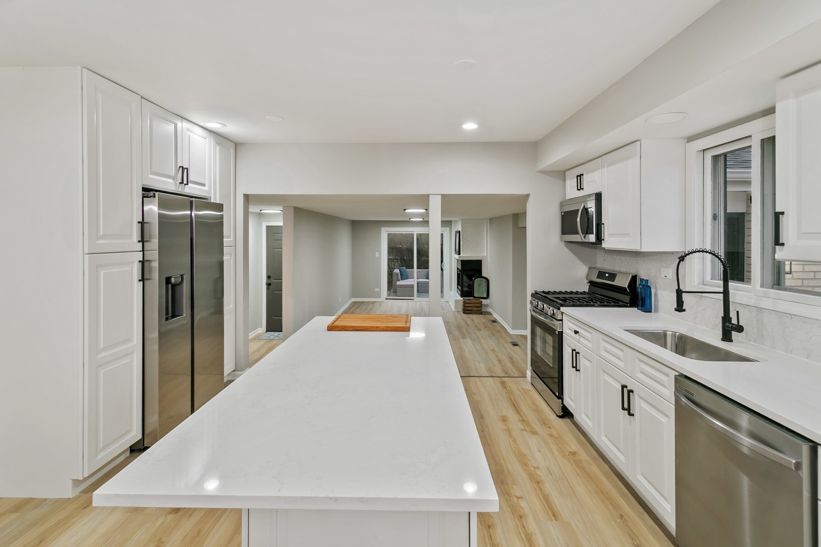 1554 Chickasaw Drive Naperville, IL 60563 - Photo 8 of 32 a large white kitchen with white cabinets and stainless steel appliances