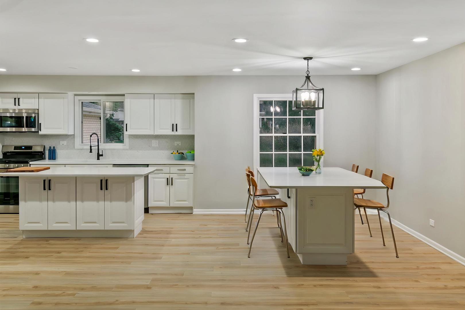 1554 Chickasaw Drive Naperville, IL 60563 - Photo 10 of 32 a kitchen with stainless steel appliances granite countertop a stove a sink a refrigerator white cabinets and wooden floor next to a window